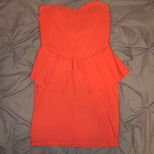 Coral mini peplum dress.